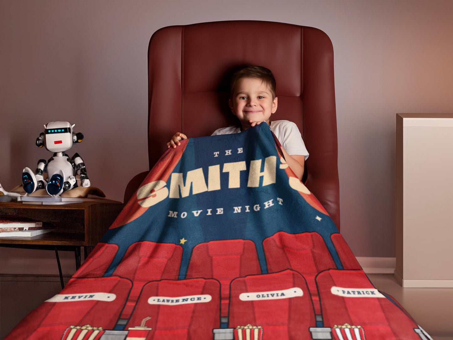 Child enjoying a cozy movie night themed throw blanket by Sam and Zoey, featuring popcorn, film reels, and a remote control on a dark background.