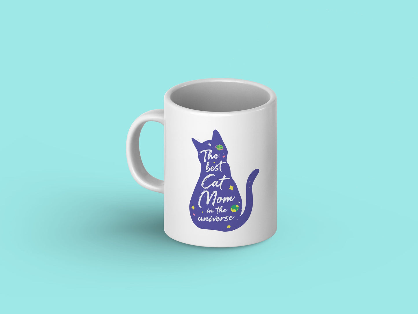 White ceramic mug with "You are the BEST Cat Mom in the Universe!" printed in bold letters against a galaxy background, featuring playful cat illustrations.