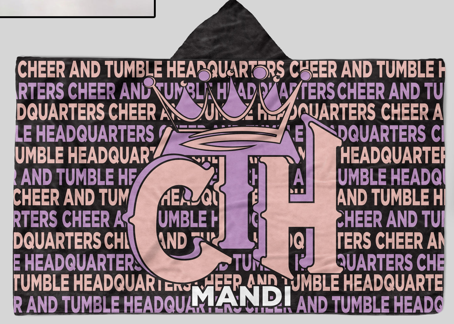 A hooded blanket with cheer & tumble headquarters and the name "MANDI" at bottom, displayed flat on a white background.