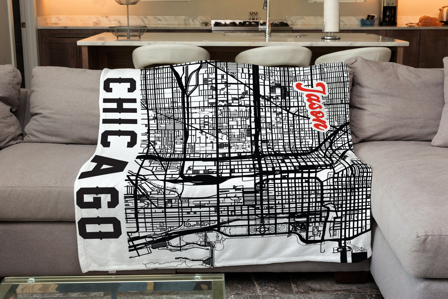 A white blanket spreaded on sofa with boston city map print and customized name, with a living room background