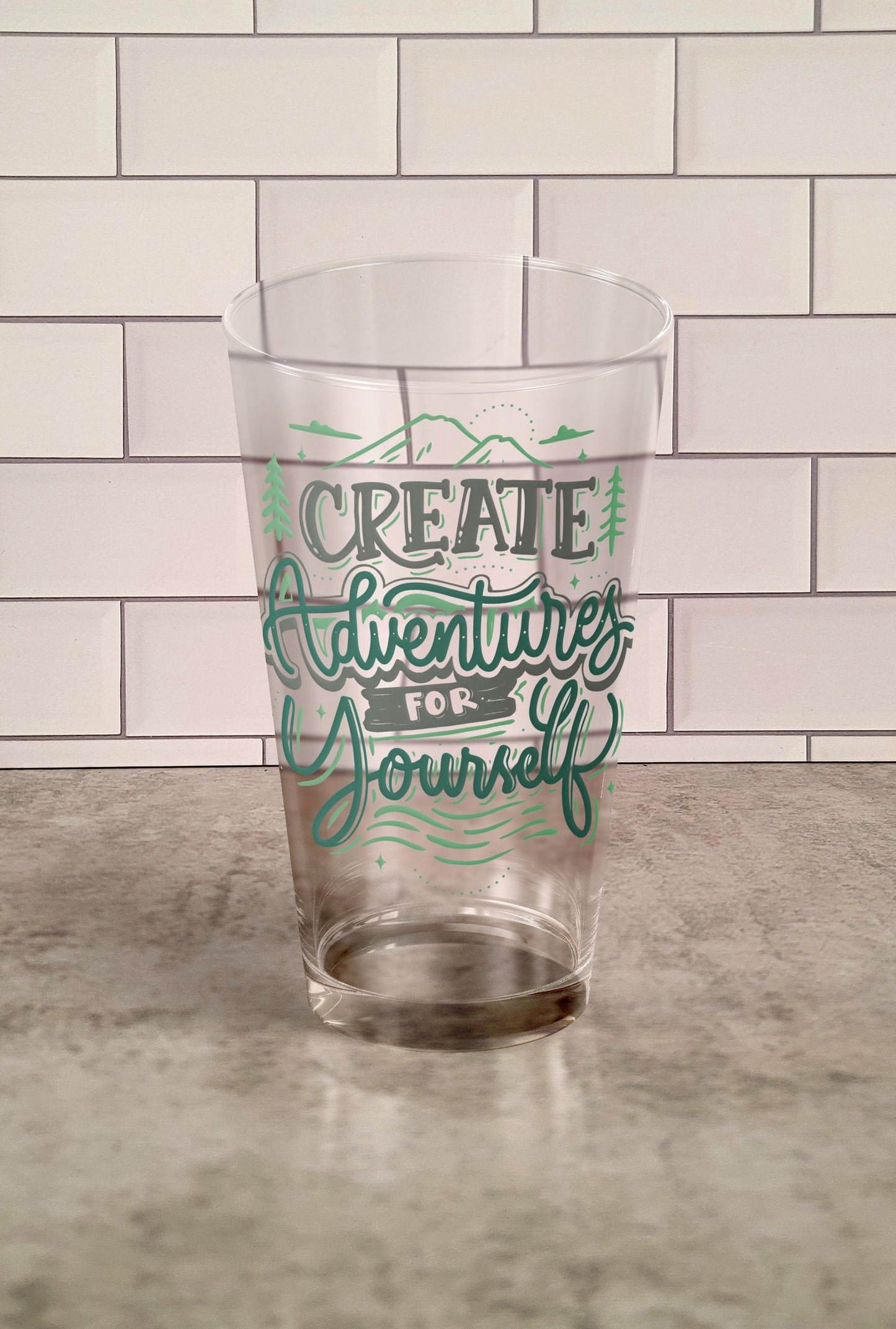 Create Adventures for Yourself transparent Tumbler Glass against a slipslap wall