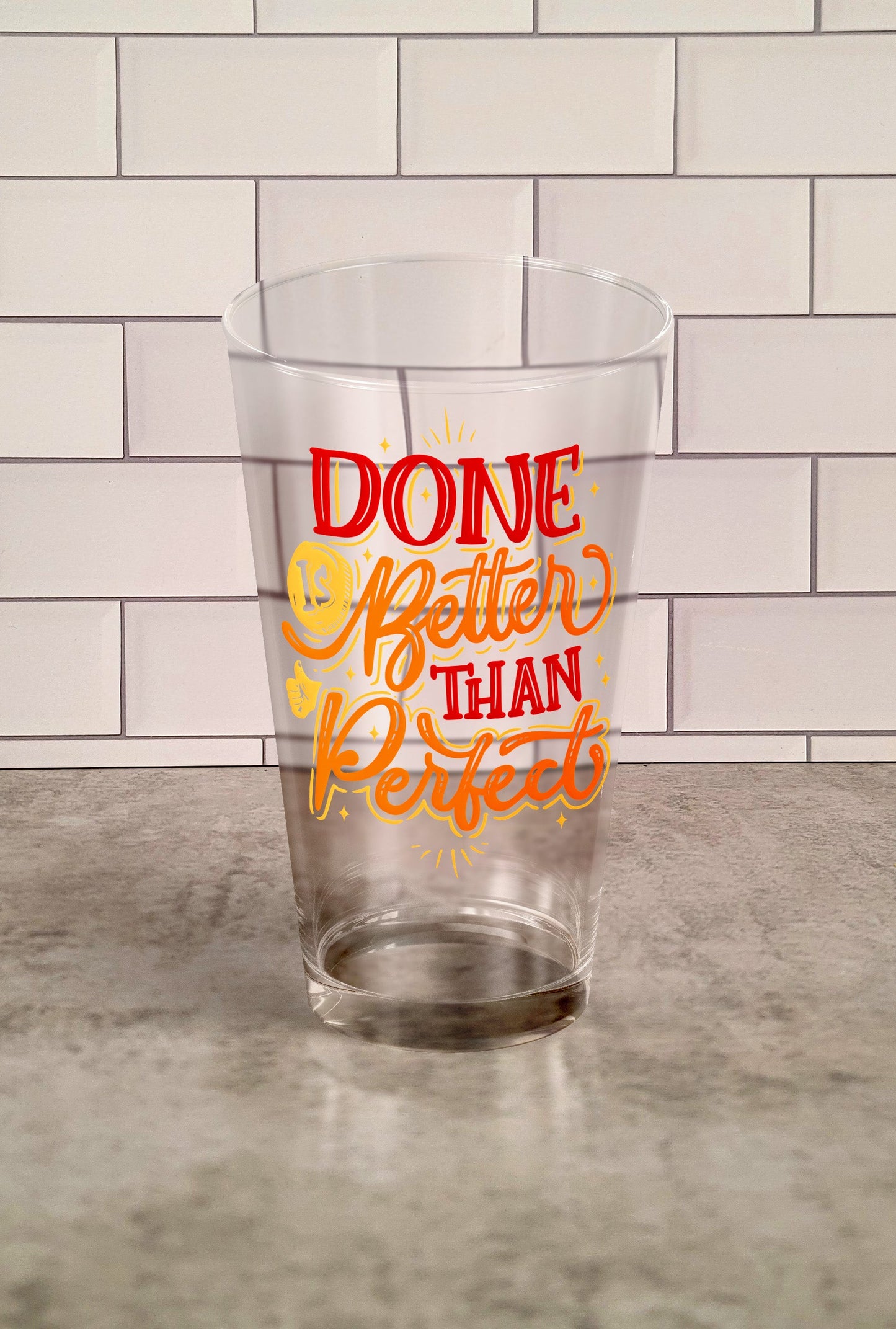 Done Is Better Than Perfect transparent Tumbler Glass against a slipslap wall