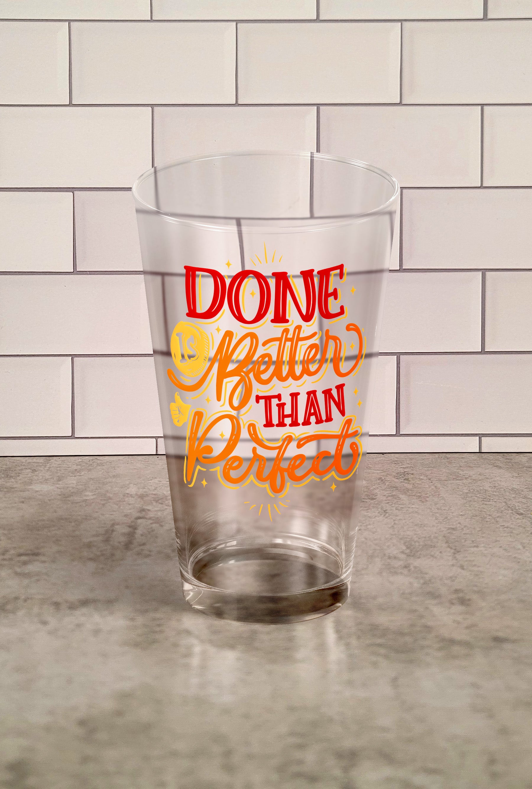 Done Is Better Than Perfect transparent Tumbler Glass against a slipslap wall
