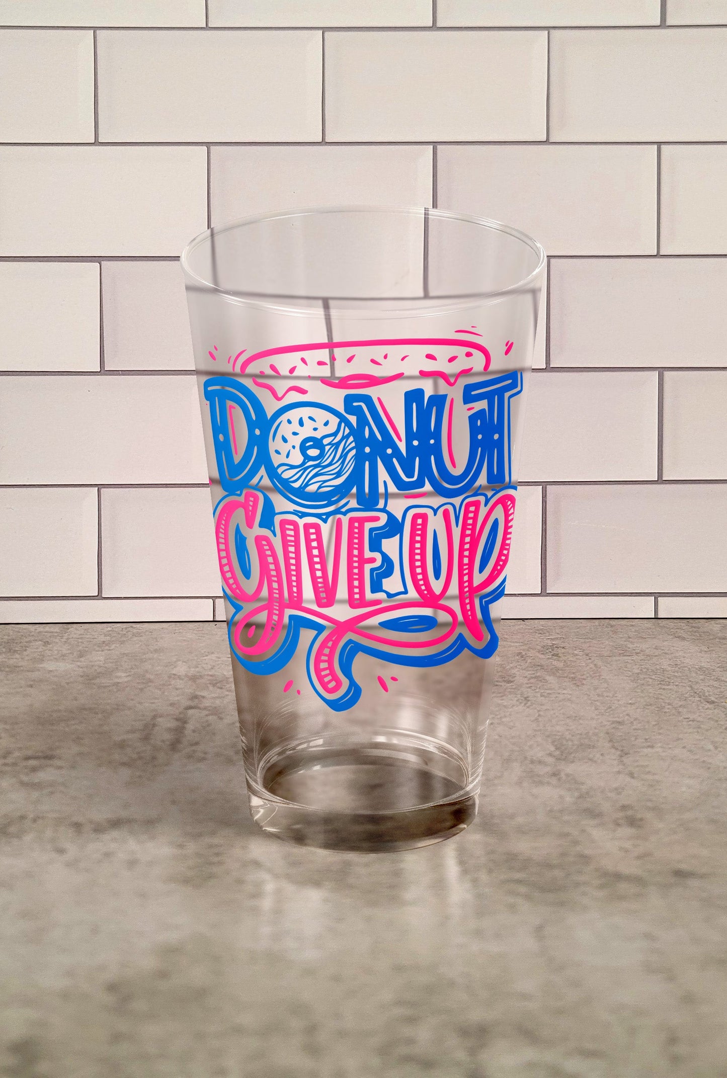 Donut Give Up transparent Tumbler Glass against a slipslap wall