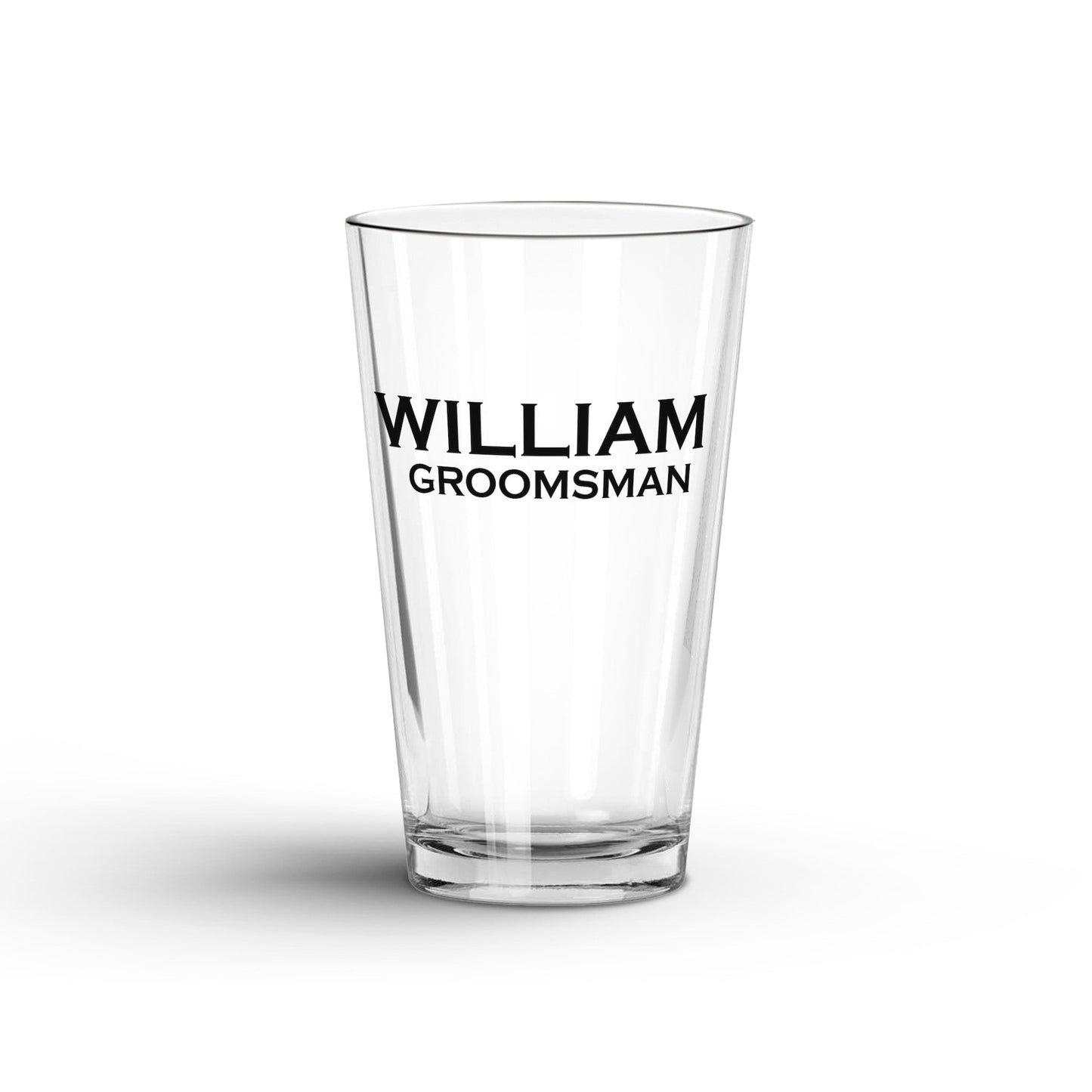 A tranparent Glass Tumbler with Personalized name 'William' and 'groomsman' printed on a white surface