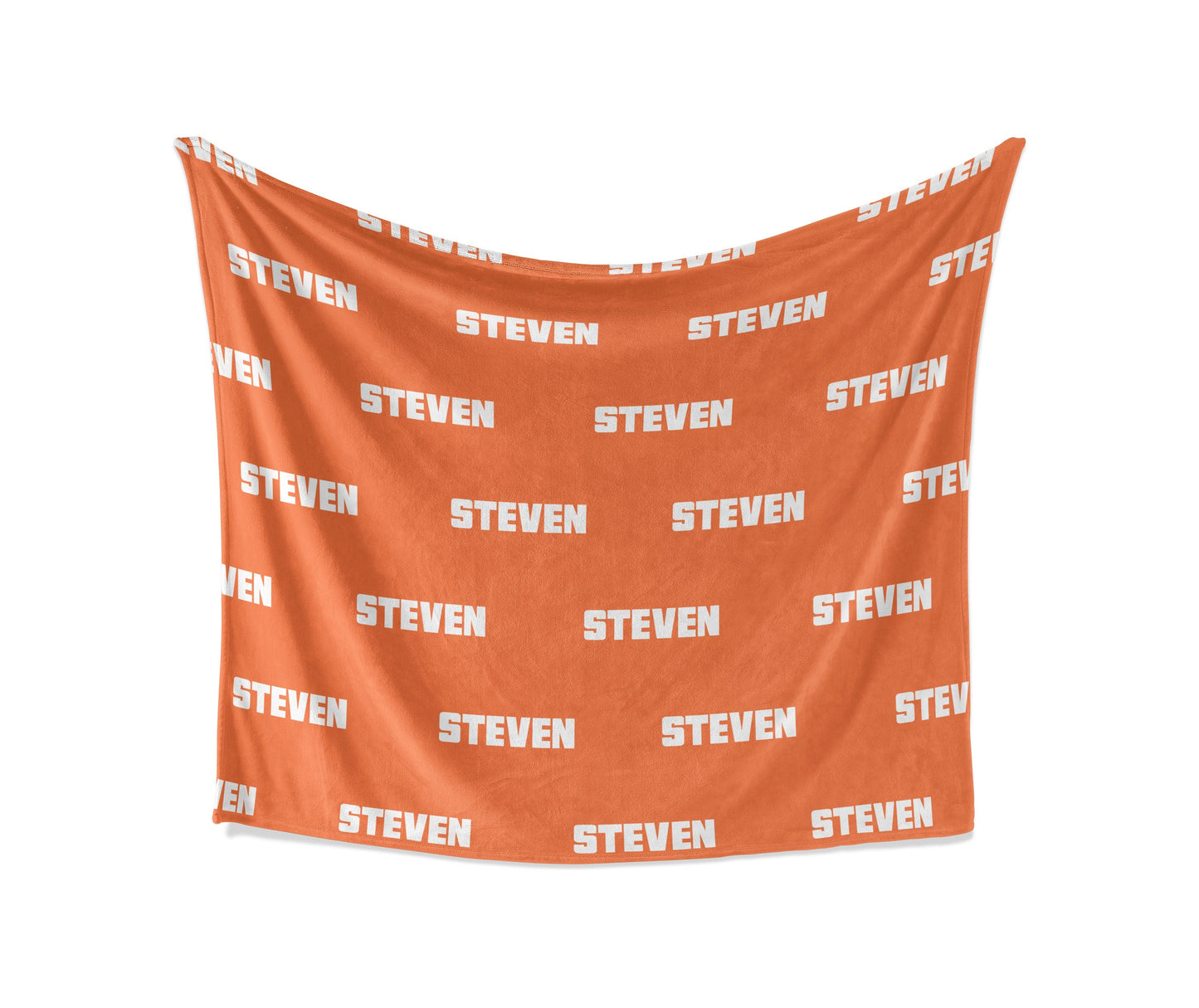 An orange fleece blanket with personalized name in a white background
