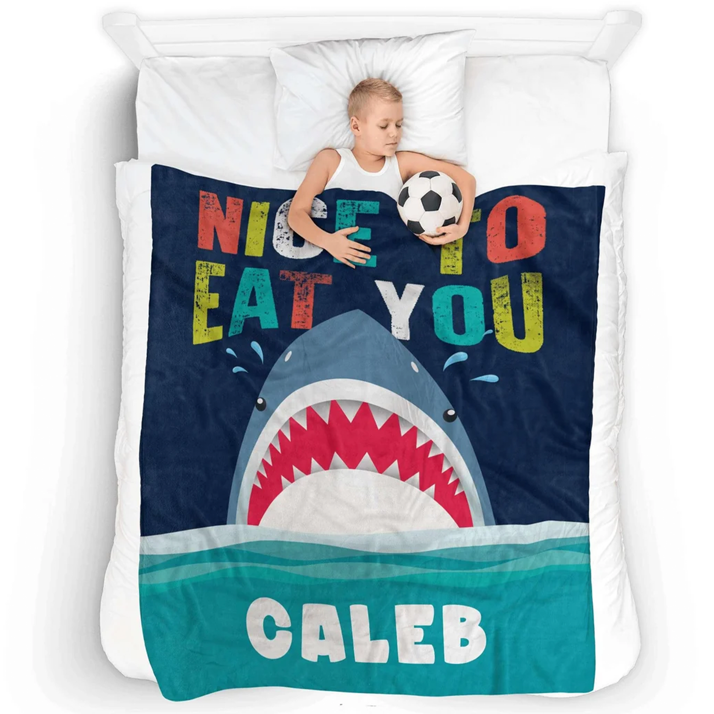 Child wrapped in personalized nice to eat you shark blanket as funny birthday gift
