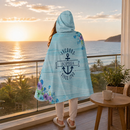 Person wearing personalized nautical anchor and flowers hooded blanket as meaningful birthday gift
