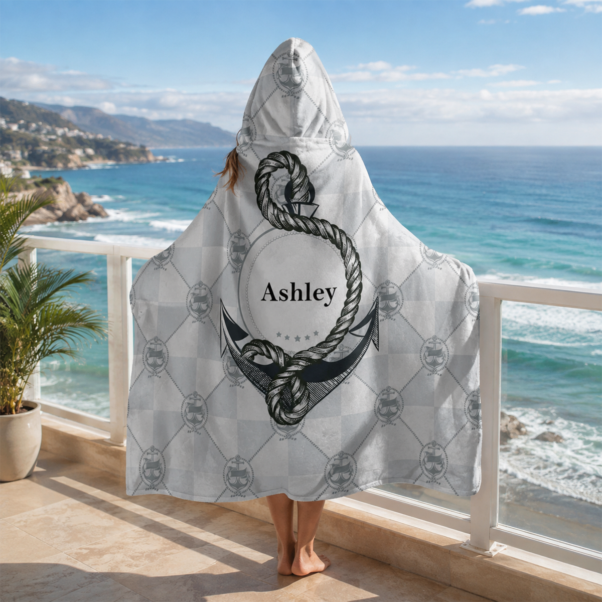 Person wearing personalized anchor hooded blanket as meaningful birthday gift
