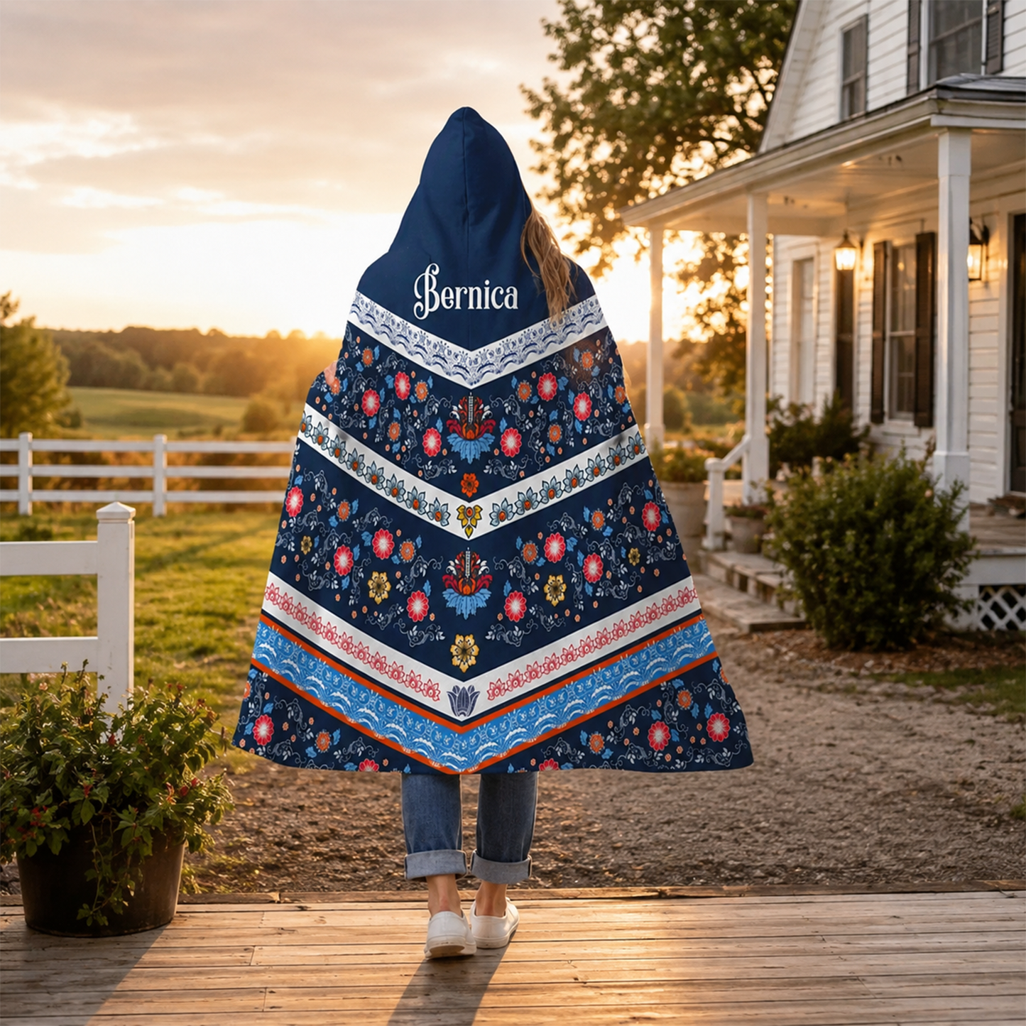 Person wearing personalized regal farm house hooded blanket as meaningful birthday gift
