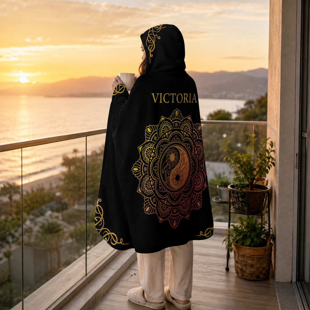 Person wearing personalized gold lotus hooded blanket as meaningful birthday gift
