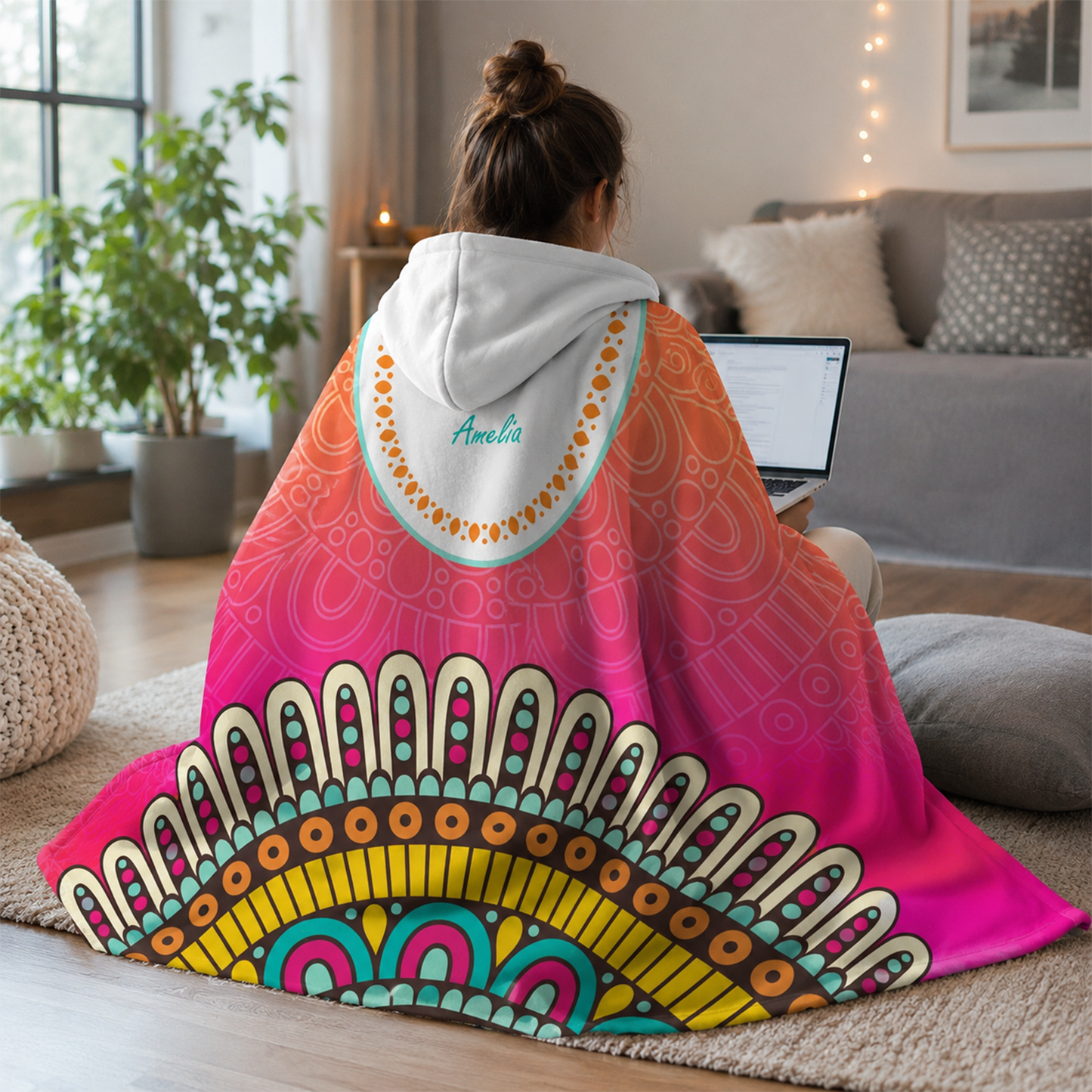 Person wearing personalized sunrise hooded blanket as meaningful birthday gift
