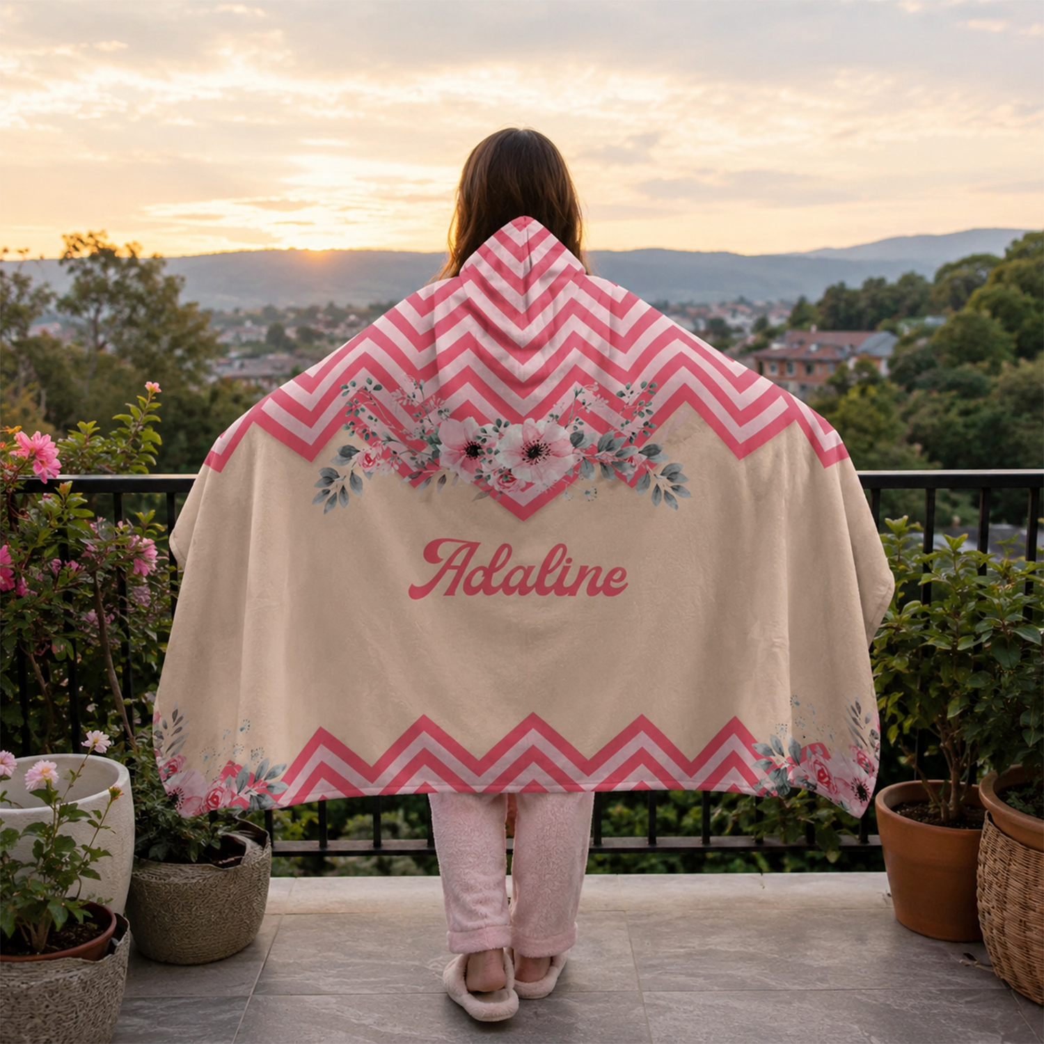 Person wearing personalized pleasant in pink hooded blanket as meaningful birthday gift
