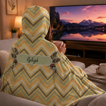 Person wearing personalized dreaming of chevron hooded blanket as meaningful birthday gift

