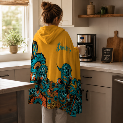 Person wearing personalized poppin paisley hooded blanket as meaningful birthday gift
