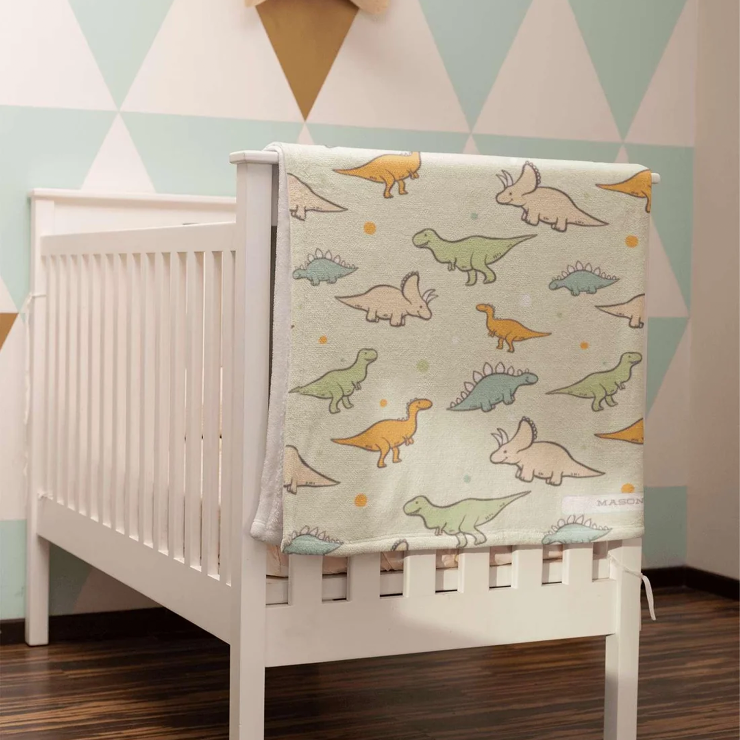 Custom name on colorful dinosaur fleece baby blanket as fun baby boy shower gift
