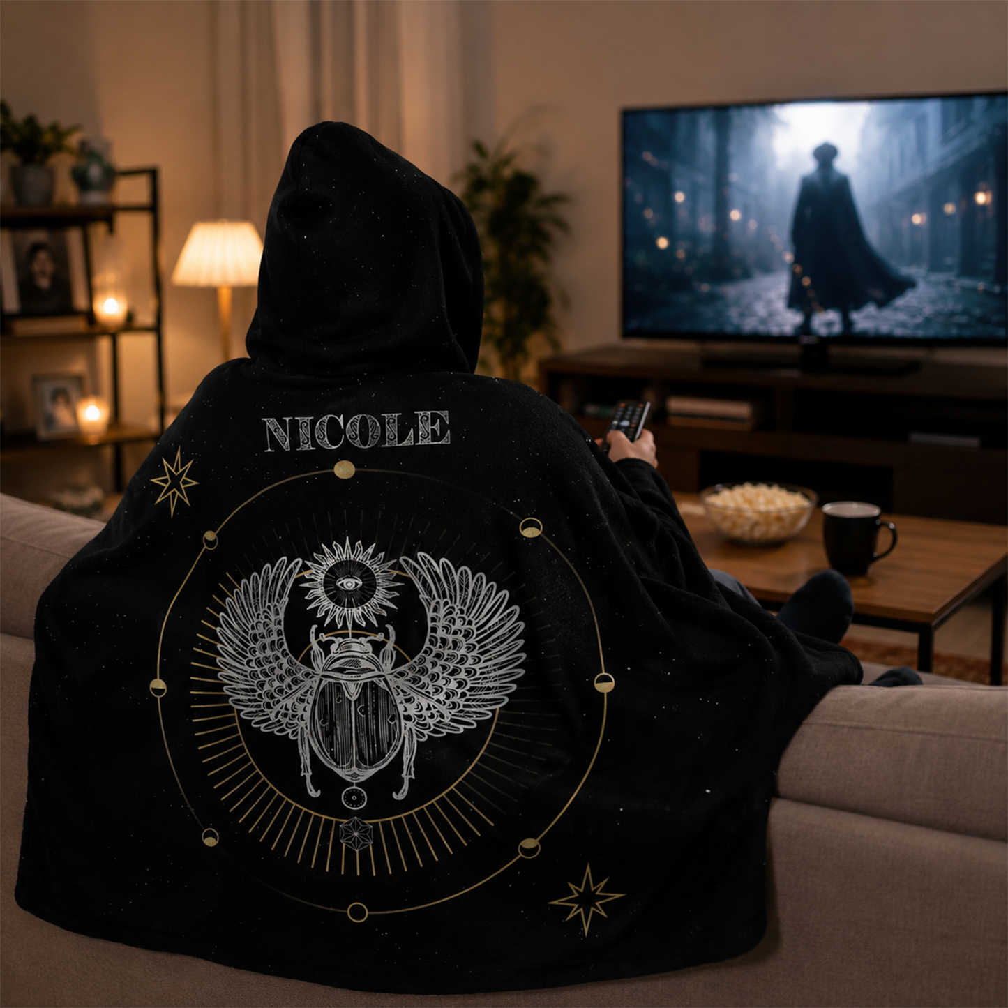 Person wearing personalized scarab hooded blanket as meaningful birthday gift

