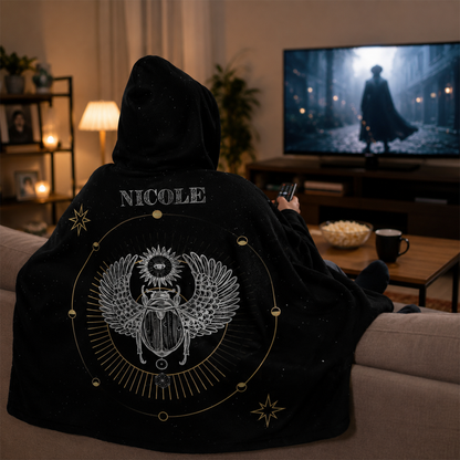 Person wearing personalized scarab hooded blanket as meaningful birthday gift
