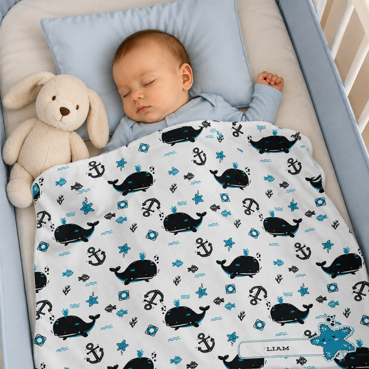 Baby wrapped in personalized white sea creature fleece blanket as ocean shower gift
