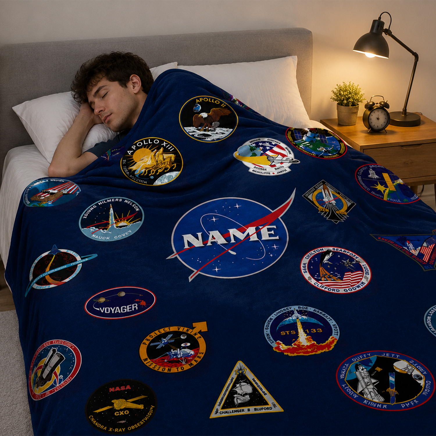 Person wrapped in personalized space mission patch throw blanket as birthday gift
