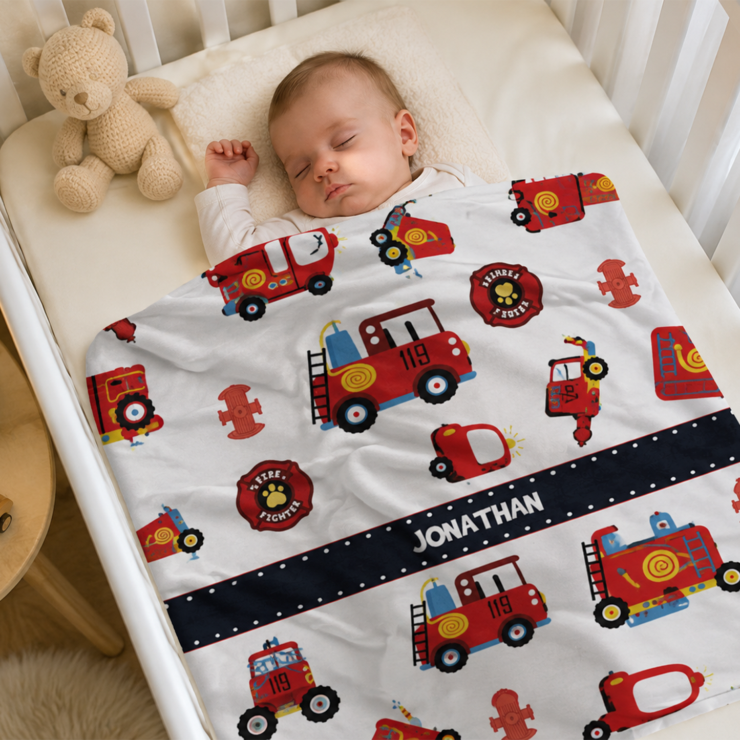 Baby boy wrapped in personalized fire truck fleece blanket as baby shower gift

