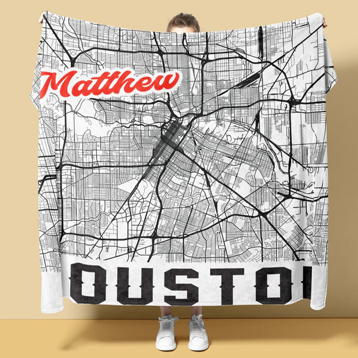 Person wrapped in personalized city map throw blanket as meaningful housewarming gift
