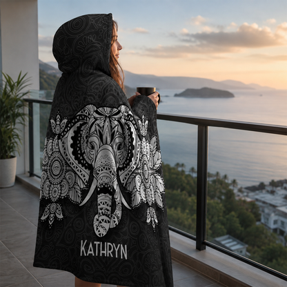 Person wearing personalized lucky charm hooded blanket as meaningful birthday gift
