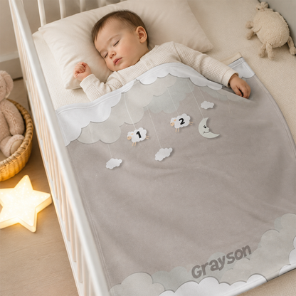 Baby wrapped in personalized counting sheep gray fleece blanket as calming shower gift
