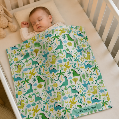 Baby boy wrapped in personalized dinosaur land fleece blanket as baby shower gift
