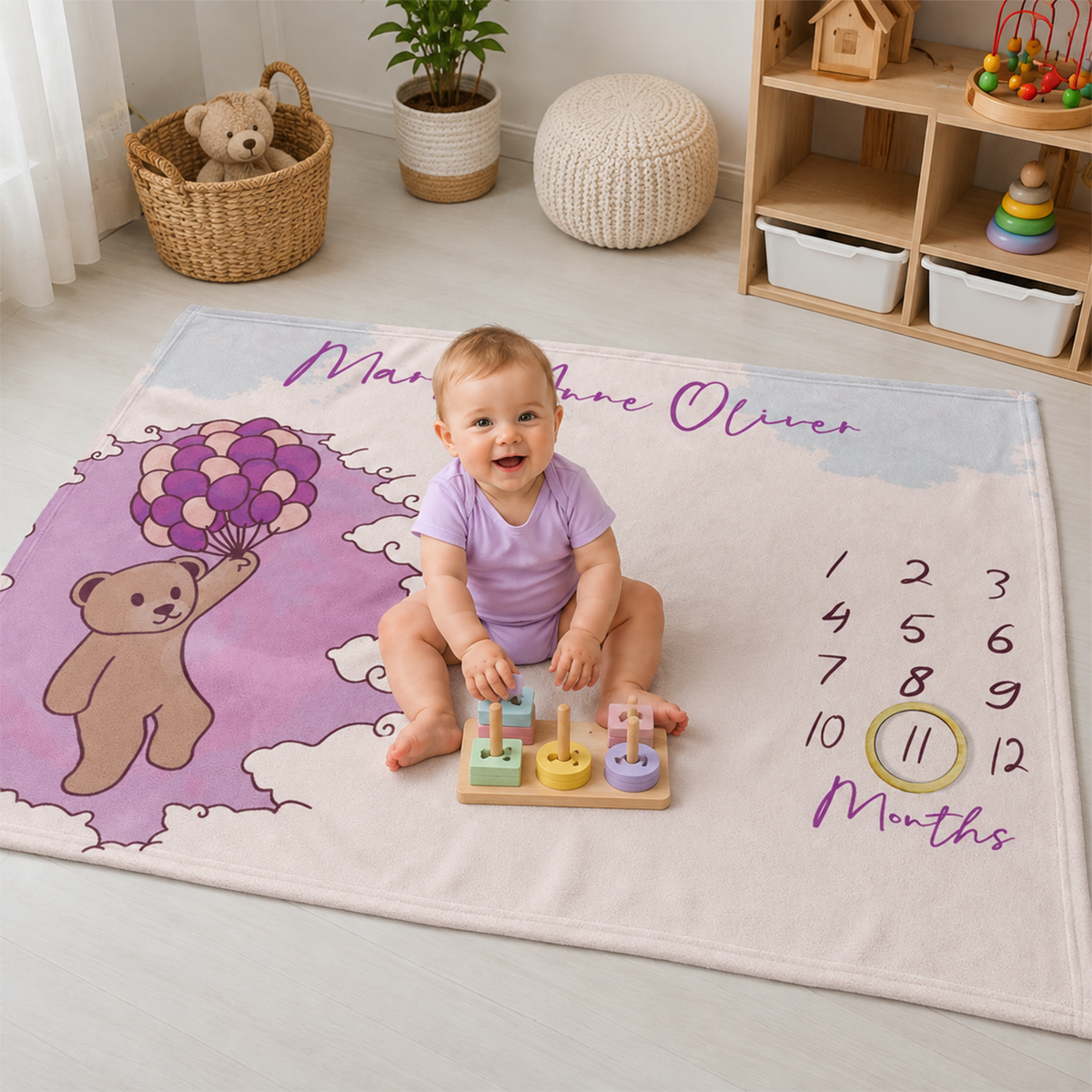 Baby girl playing in personalized pink bear balloons fleece blanket as shower gift

