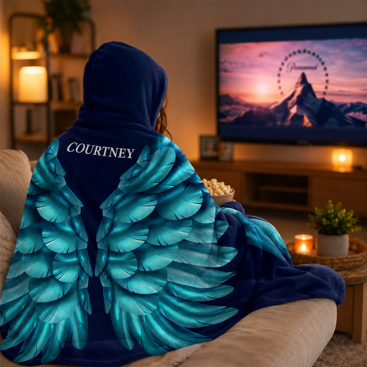 Person wearing personalized turquoise angel wings hooded blanket as meaningful gift
