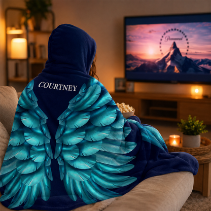 Person wearing personalized turquoise angel wings hooded blanket as meaningful gift
