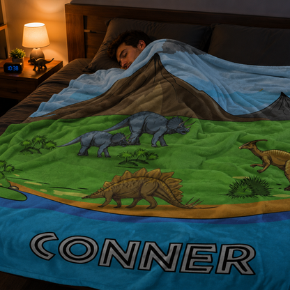 Close-up of custom name on dinosaur park kids polyester fleece throw blanket detail
