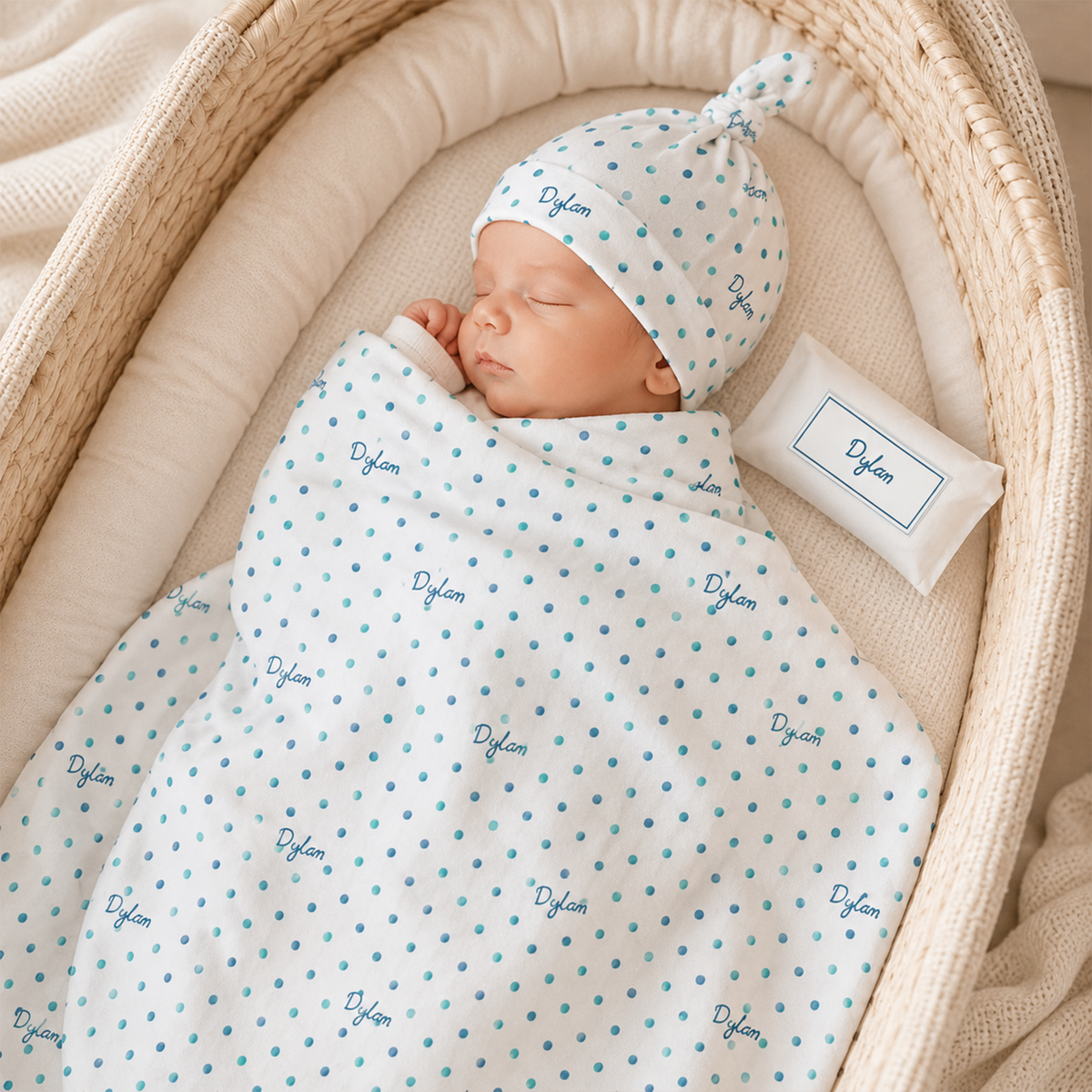 Newborn wrapped in personalized watercolor polka dot swaddle as baby shower gift
