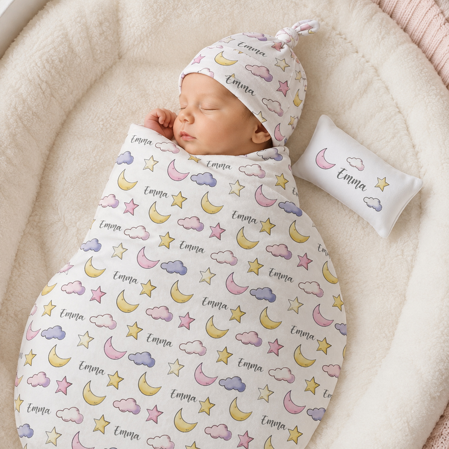 Newborn wrapped in personalized moon and stars swaddle as dreamy baby shower gift
