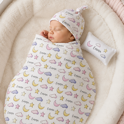 Newborn wrapped in personalized moon and stars swaddle as dreamy baby shower gift
