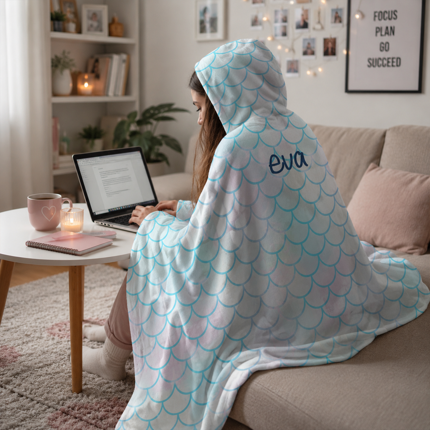 Woman wearing personalized aquamarine hooded blanket as coastal birthday gift
