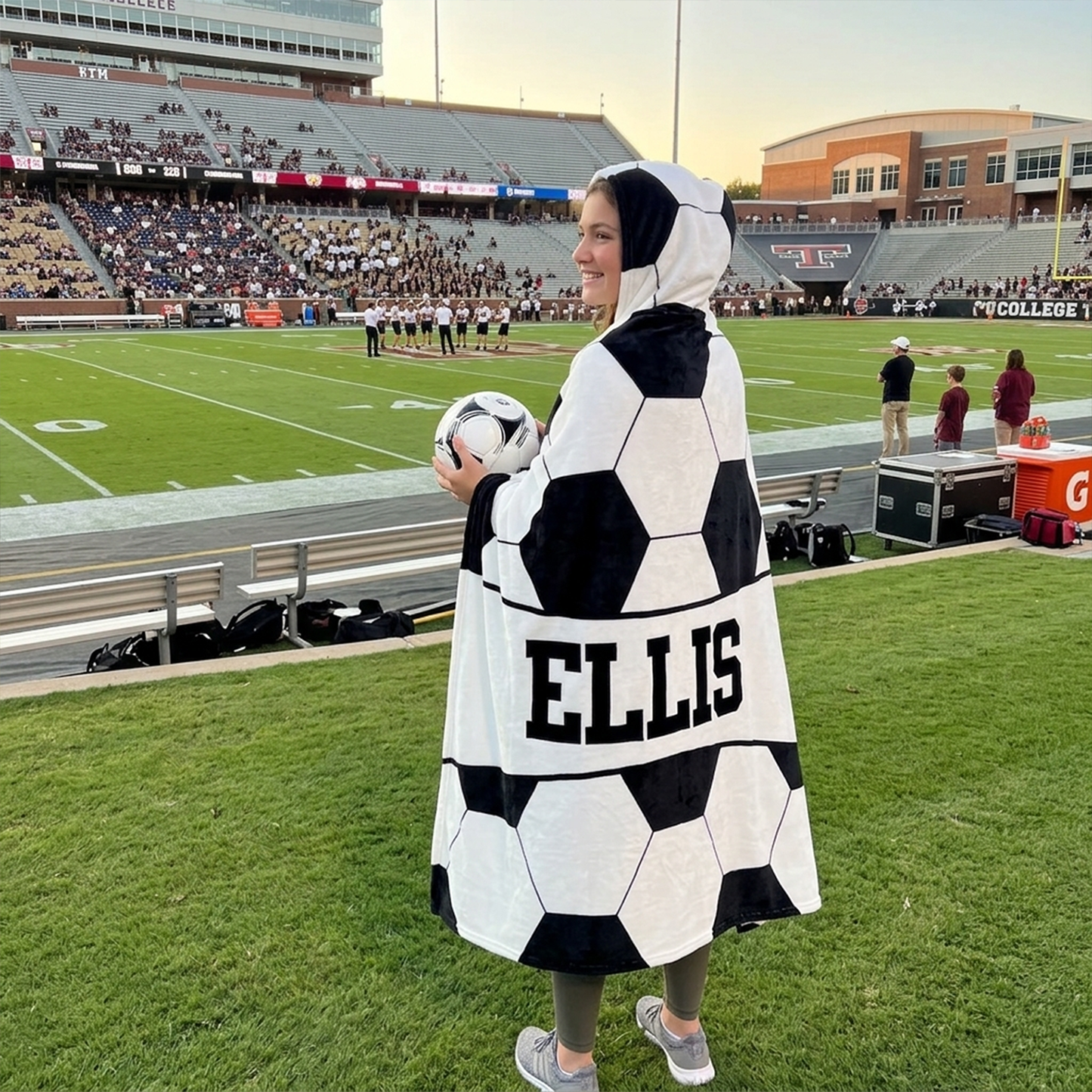 Soccer player wearing personalized hooded fleece blanket as end of season sports gift
