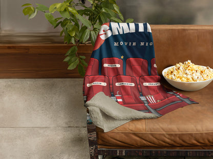 Cozy movie night themed throw blanket by Sam and Zoey, adorned with popcorn, film reels, and a remote control design.
