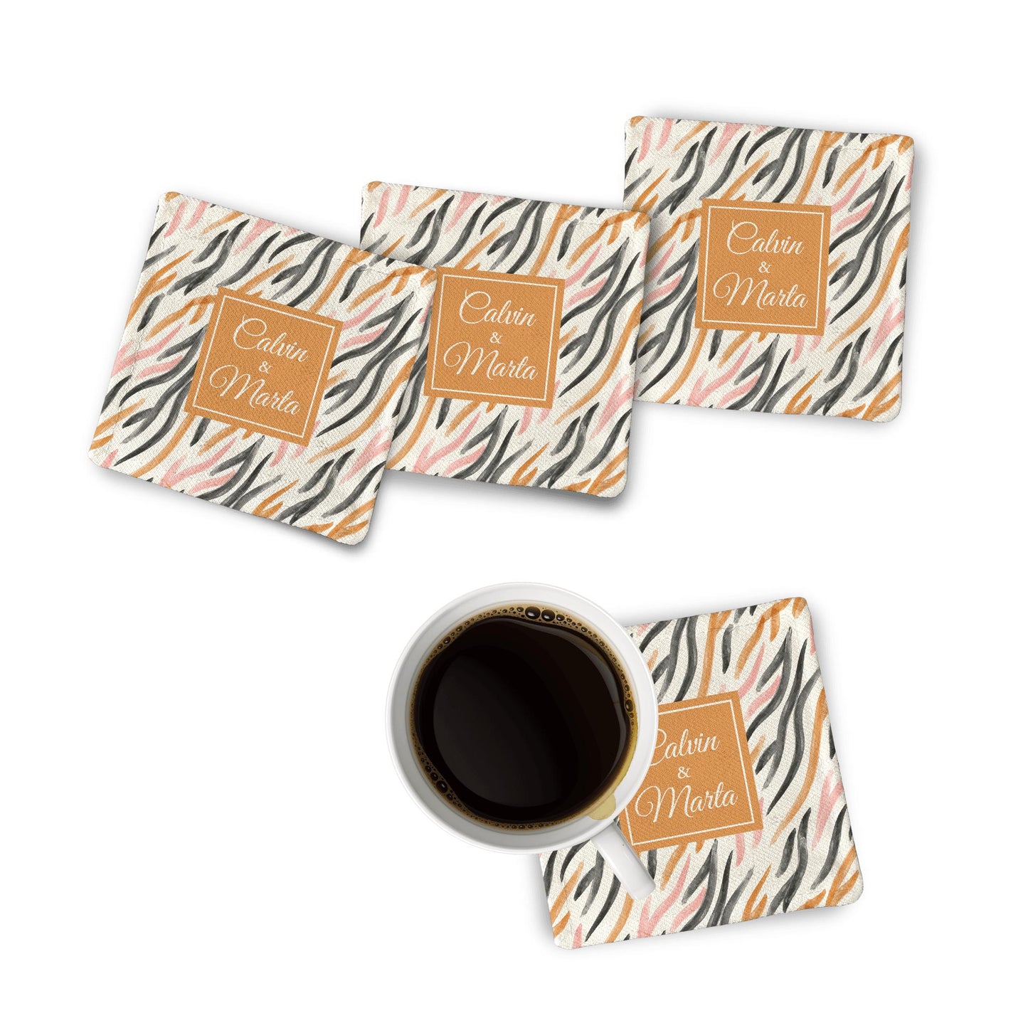 4 Orange watercolor Fabric Coasters on a white surface along with a coffee mug