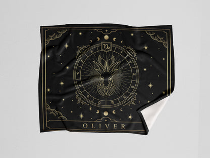 A black throw sherpa blanket with capricorn Zodiac sign and customized name with a white background