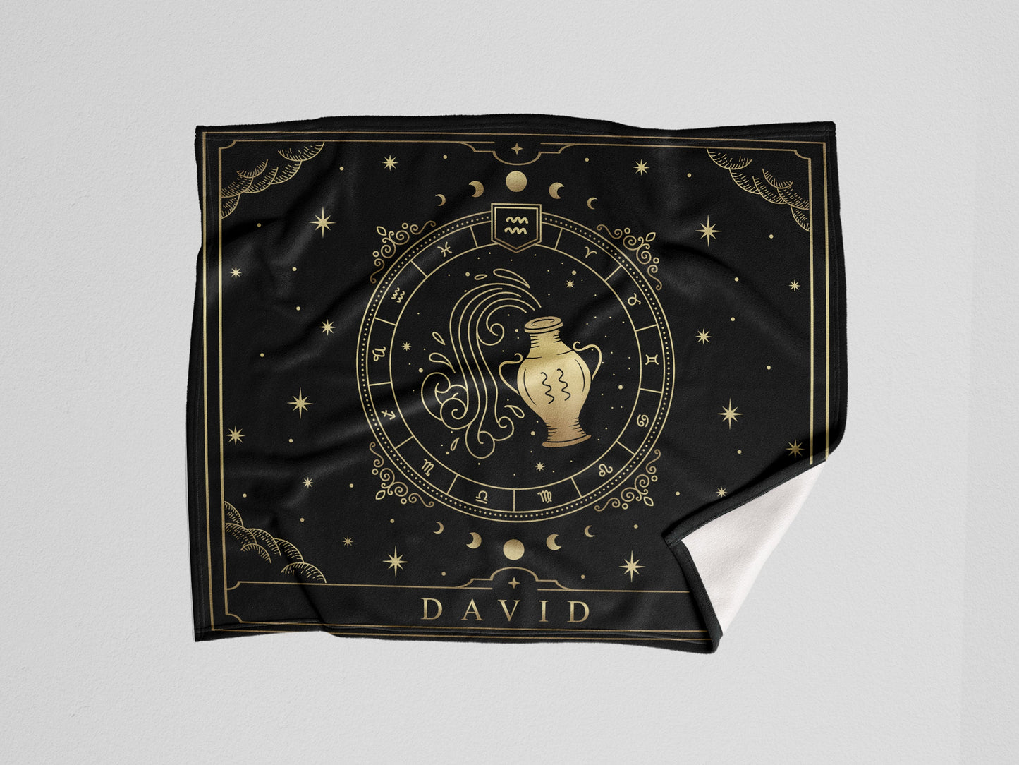 A black throw fleece blanket with aquarius Zodiac sign and customized name with a white background