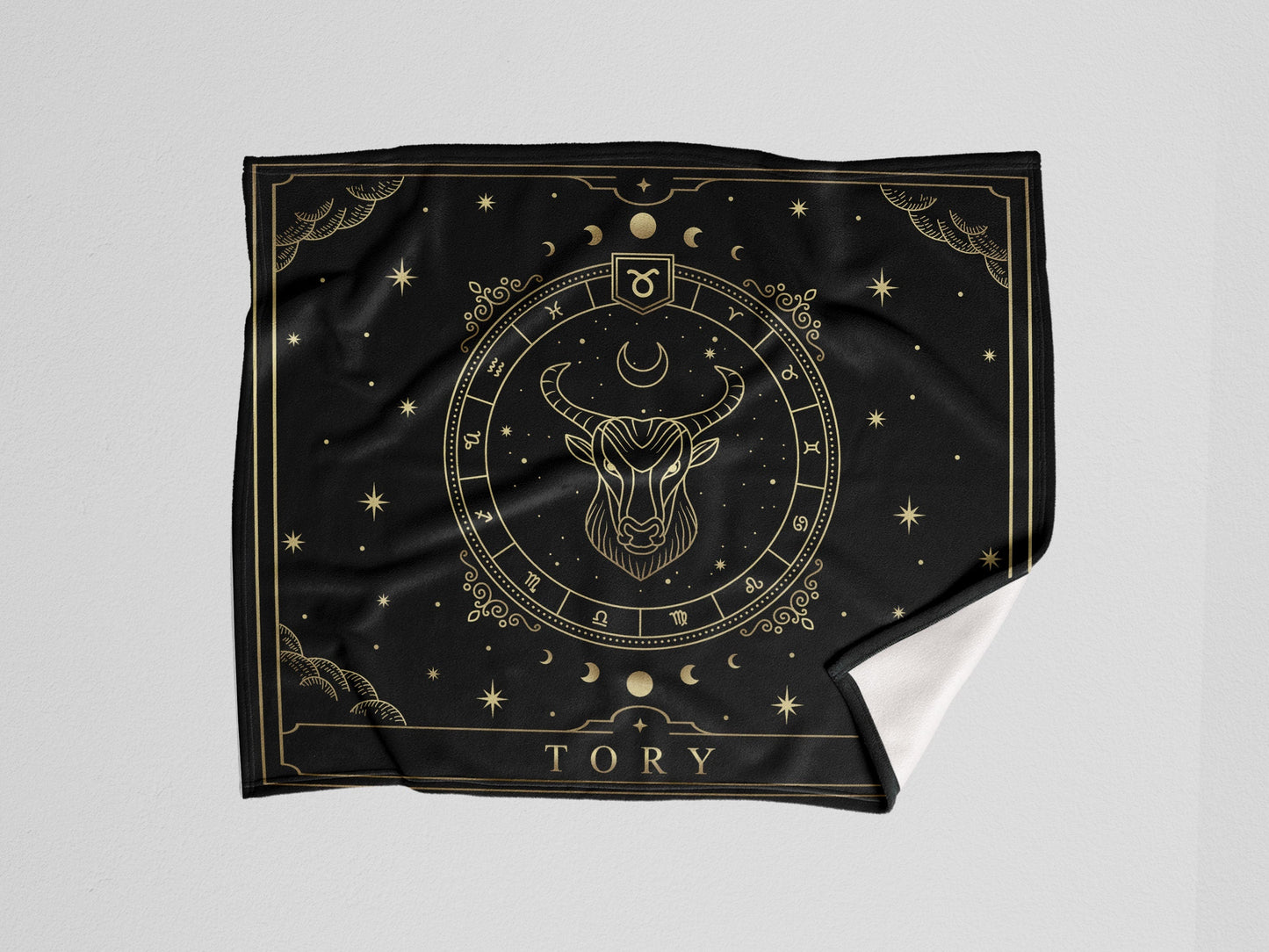 A black throw wooven blanket with Taurus Zodiac sign and customized name with a white background