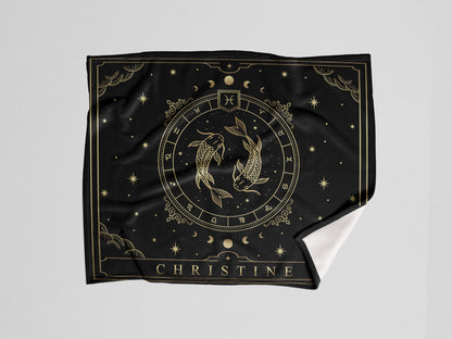 A black throw fleece blanket with pisces Zodiac sign and customized name with a white background