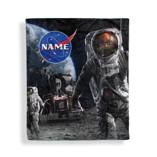 A throw blanket with Man on the moon design and customized name, displayed flat on white surface